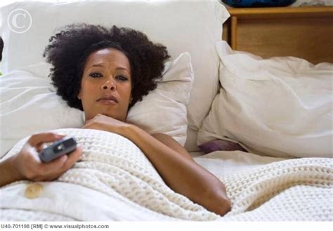 african american woman watching tv in bed sbm