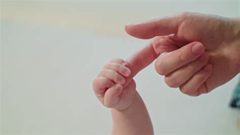 Mother And Newborn Daughter Hand In Hand Slow Motion