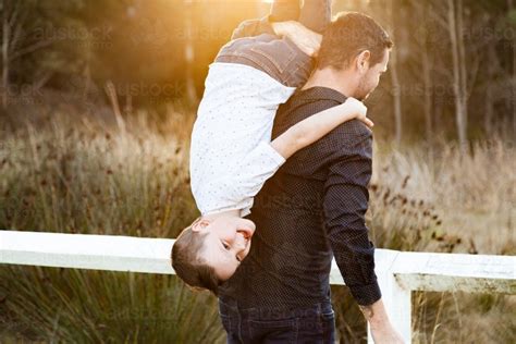 image  father tipping son   shoulder  carry  austockphoto