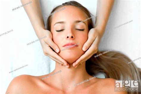 Young Blond Woman Receiving A Head Massage In A Spa Center With Eyes