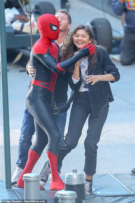 tom holland swings into action with zendaya in his arms on set of spider man far from home