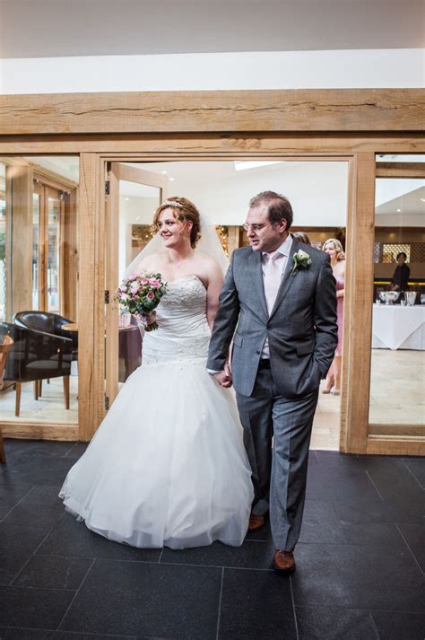 rustic same sex wedding at mythe barn with brides in traditional ivory gowns by mori lee and