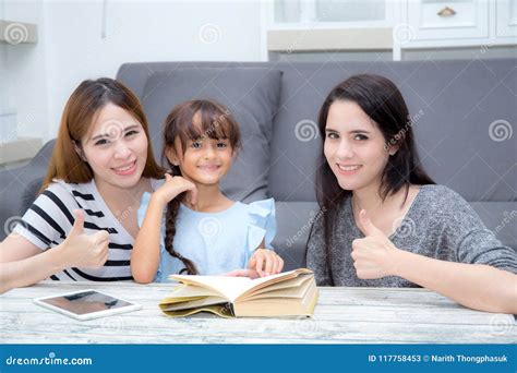 happy family mother aunt freind  daughter teaching read   stock