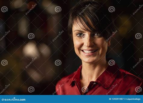 Headshot Of Mature Beautiful Woman Looking At Camera And Smiling While