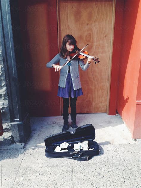 Eleven Year Old Girl Playing Violin At Public Market By Rialto Images