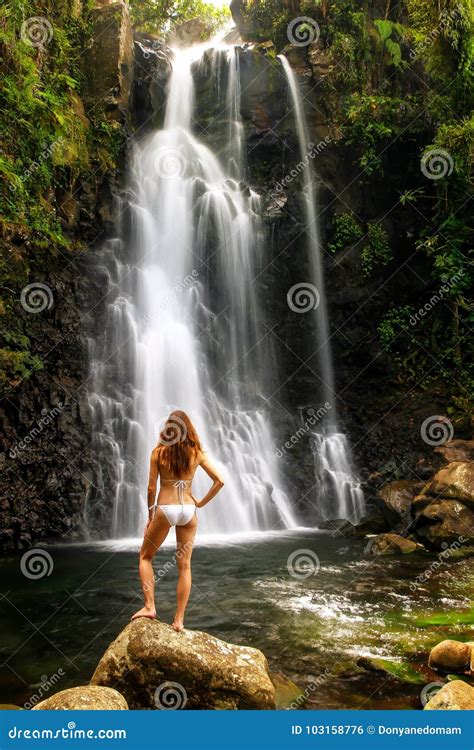 Young Woman In Bikini Standing By Middle Tavoro Waterfalls In Bo Stock