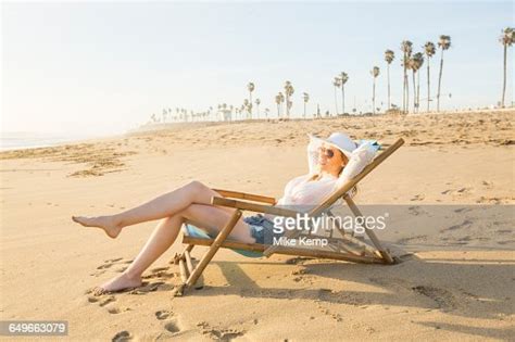 caucasian woman laying on beach photo getty images