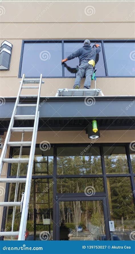 professional window cleaner   awning editorial photography image  corporate building