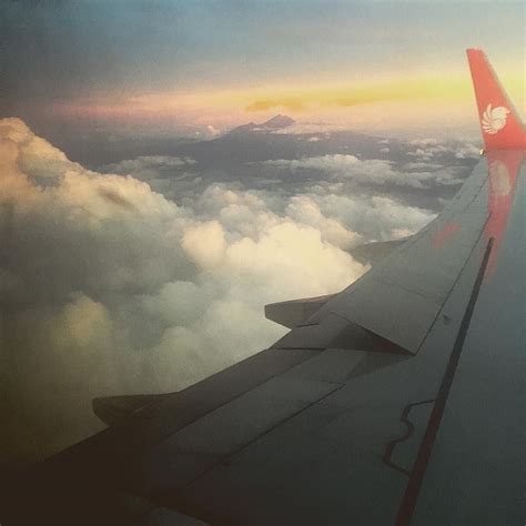 flying through the indonesian sky mount rinjani just poking out the