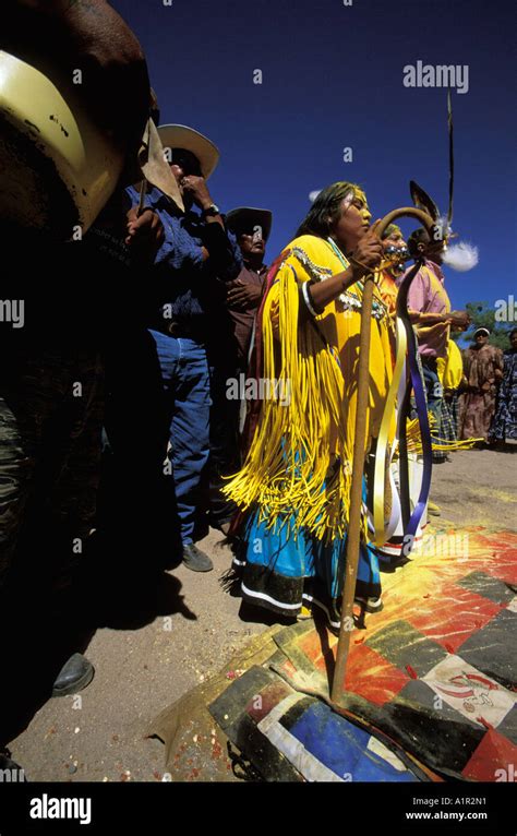 an apache girl dances with her godmother and godfather at her sunrise
