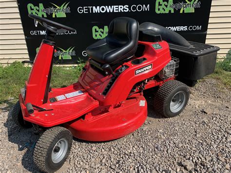 red lawn mower sitting  front   sign   getmowers