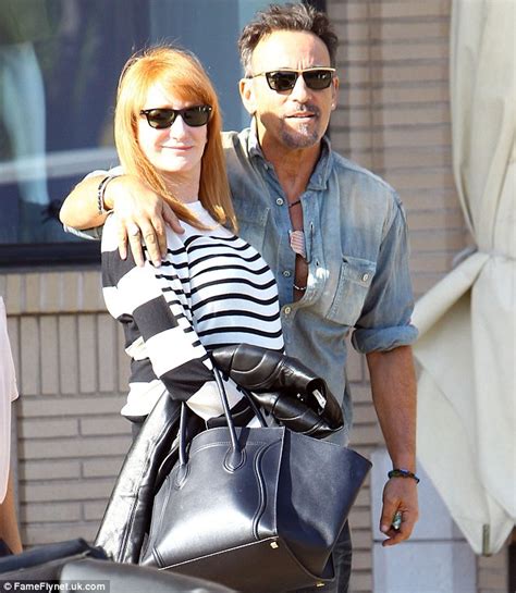 bruce springsteen flashes peace sign as he drives wife patti scialfa