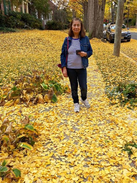 Latina Woman Enjoying The Fall Foliage In November In Autumn Stock