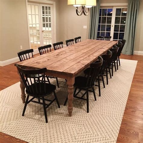 large wooden table sitting  top   white rug