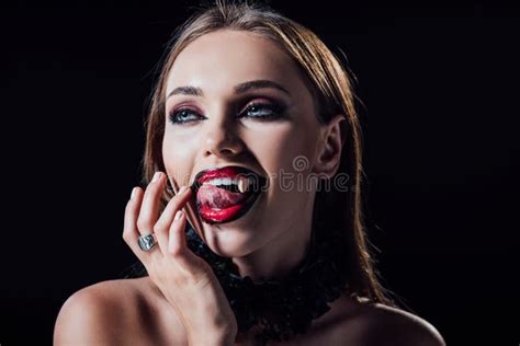 Scary Vampire Girl Showing Fangs In Black Gothic Dress Stock Image