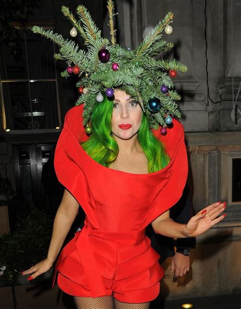 lady gaga wears a christmas tree with a star and baubles on her head as
