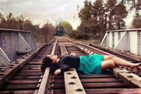 sad girl lying on railway track wallpaper best hd wallpapers