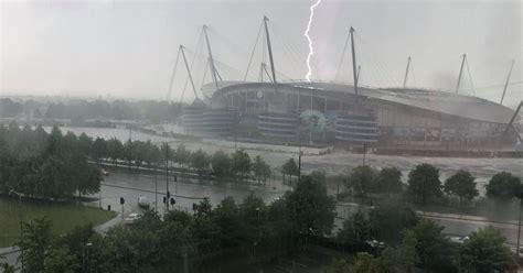 greater manchester weather updates  heavy downpours hit  flash flooding