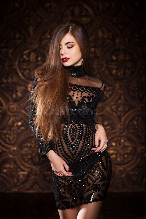 Elegant Woman Wearing Black Dress Posing In A Way Showing Her Perfect