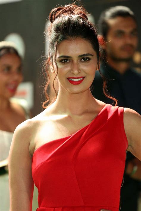 meenakshi dixit showcasing her sexy curves in a red dress