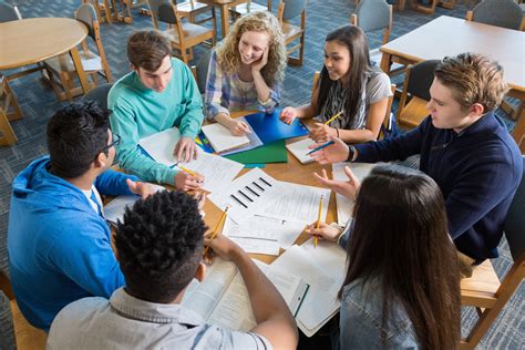 large diverse group  students studying   library teacher