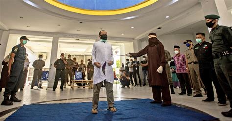 two men publicly caned 77 times for having sex in indonesia
