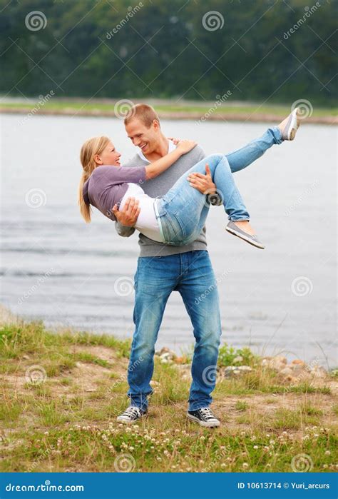 young guy carrying  girlfriend   arms stock photo image  length girl