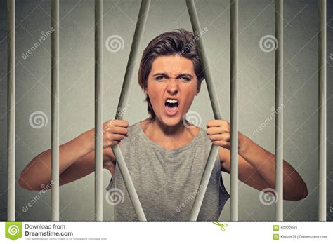 desperate angry woman bending bars of her prison cell stock image image of despair financial