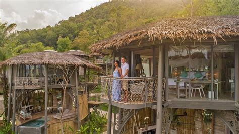people  standing   balcony   tropical house  thatched roof  balconies
