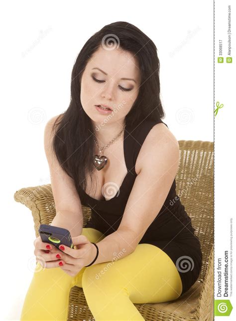 woman black dress yellow legs phone sit serious stock image image of