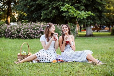 Premium Photo Two Fashionable Girlfriends Wearing Polka Dot Dresses