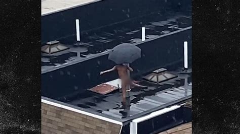 nyc dweller does naked rooftop dancing in the rain umbrella included