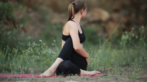 A Pregnant Woman Does Gymnastics Outdoors â Splits With