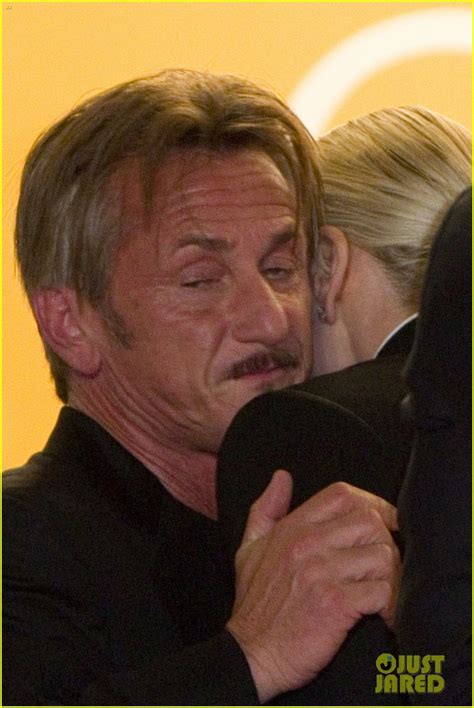 sean penn and charlize theron share a kiss while leaving
