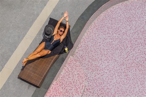 Beautiful Woman Enjoying Summer And Tanning At The Swimming Pool Stock