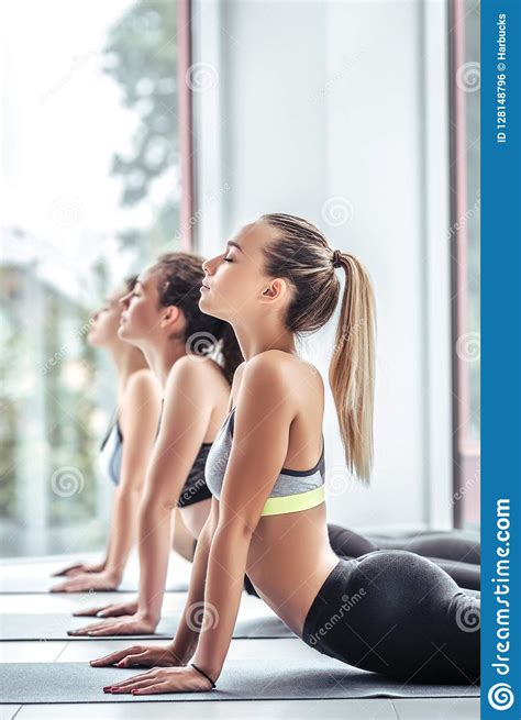 Fitness Females Doing Backbend Exercise On Yoga Mat In