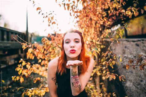 Ginger Woman Blowing A Kiss By Stocksy Contributor Thais Ramos