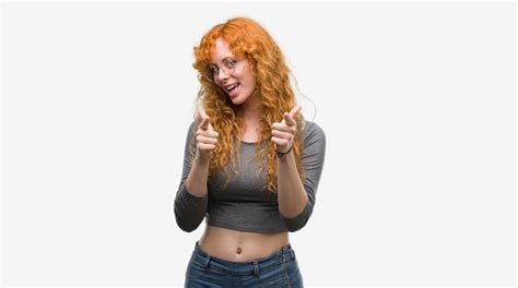 Young Redhead Woman Pointing Fingers To Camera With Happy And Funny
