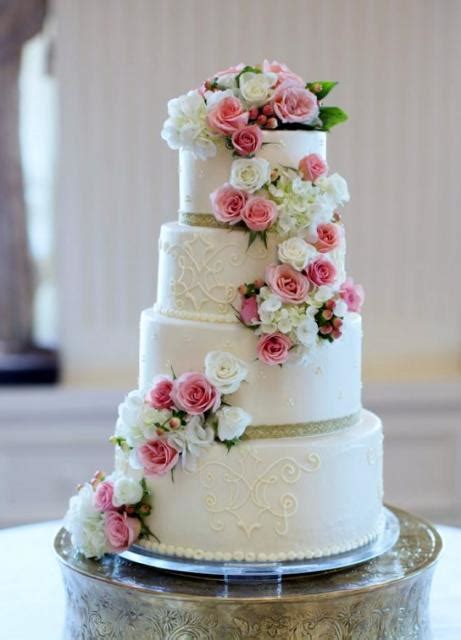 4 tier round white wedding cake with cascading pink