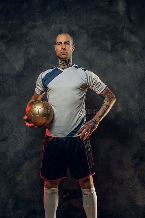hot tattooed bald fashionable male soccer player posing   studio   photoshoot