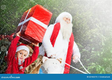 helper  santa claus brings gifts   snow day stock image