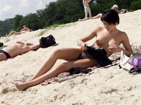 short haired brunette is undressing at public beach russian sexy girls