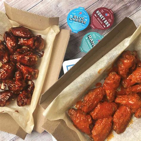 dominos unveils   improved chicken wings  sauces