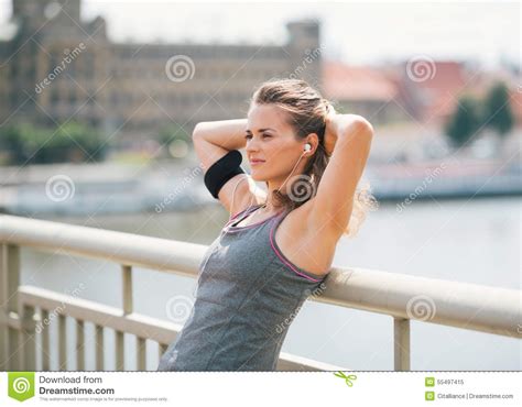 Woman Leaning Back With Hands Behind Head Relaxing On