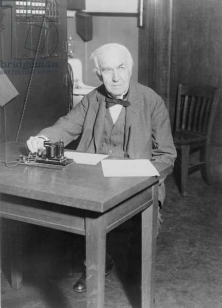 Thomas Edison Seated At Desk Demonstrating An Old Telegraph