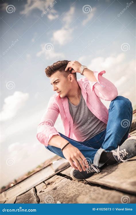 thoughtful young man  sitting  stock image image  clouds