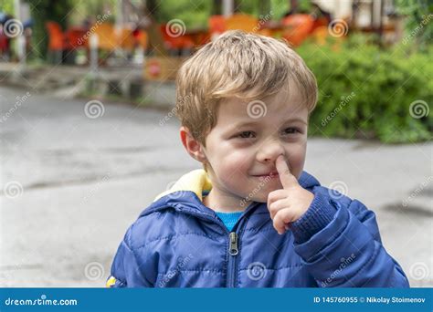 small child picking  nose  making faces stock image image  cheerful handsome