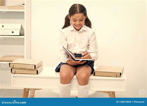 enjoying studying girl child reads book  sit  table  pile