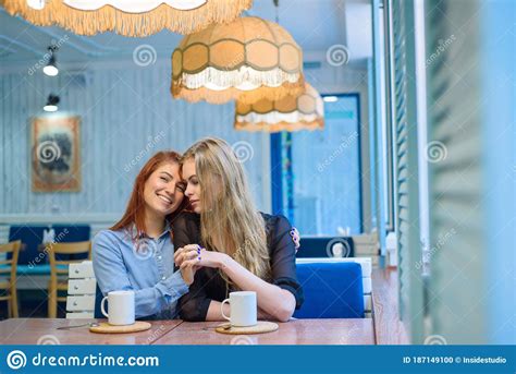 Same Sex Relationships Happy Lesbian Couple Sitting In A Cafe Girls