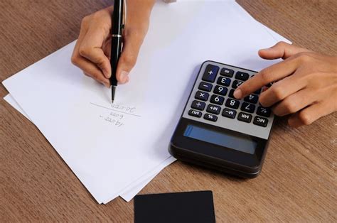 photo closeup  person calculating  calculator  writing